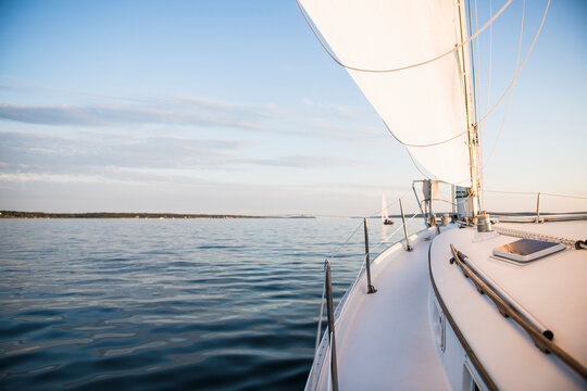 Boat sailing during golden hour summer sunset