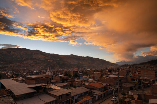 Orange clouds at sunset over Huaraz and the Cordillera Blanca