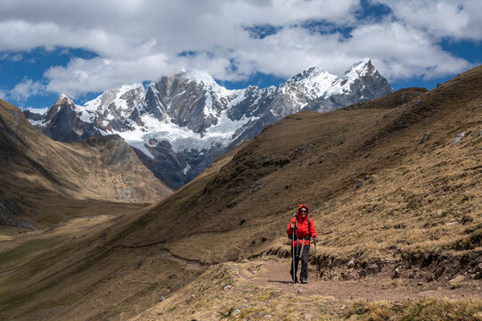 One person using poles hikes on a trail at Cordillera Huayhuash