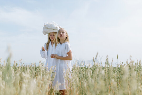 Little blondes in the village carry the washed laundry