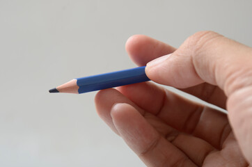 hand with blue color pencil