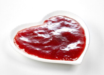 Small heart shaped bowl of red marmalade ketchup