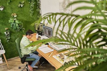 designer creates new designs sitting in his studio