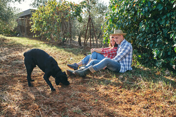 young couple take a break from a day's work in the countryside with th