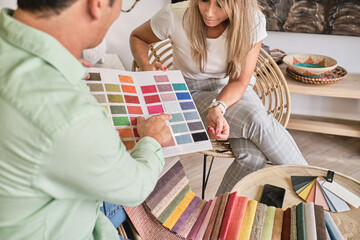 fabric salesman shows a lady the color chart
