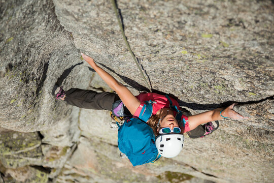 Woman rock climbs Via Amici on Lochberg, Furka Pass, Uri, Switzerland