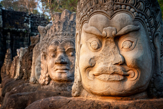 Angkor Archaeological Park, Siem Reap, Cambodia. South gate of Angkor Thom.  Bad gods in hindu epic tale of a tug of war between good vs evil in the story the churning of the sea of milk.