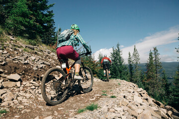 Two female bikers ride on a trail at Timberline Bike Park in Oregon.