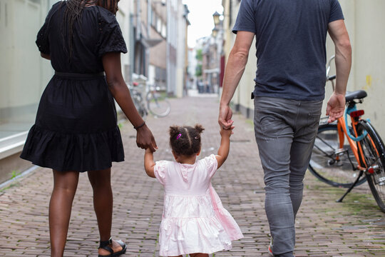 An interracial family walking in a Dutch city