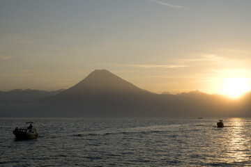 Guatemala, Central America: Lake Atitlán (Atitlan) 
with volcanos - sunset with boat