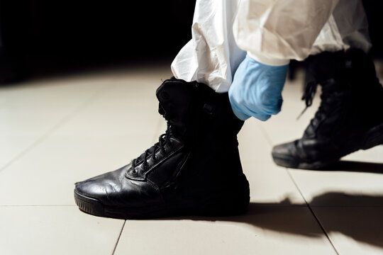 military putting on protective boots