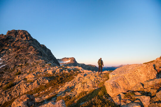 Rear view of backpacker exploring mountain range.