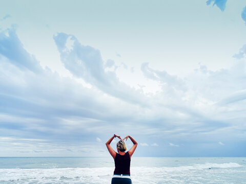 attractive blonde woman enjoying the beach on a cloudy day