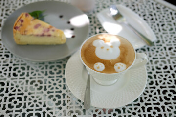 hot cappuccino mocha coffee with latte art & raspberry cheesecake.