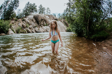 Young girl playing on the banks of the Platte River