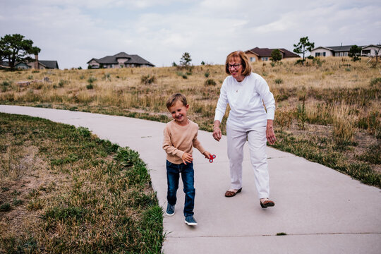 Grandma and grandson playing outside on a cloudy day