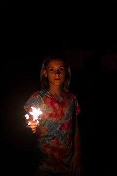 Girl holding sparkler on the 4th of july in kansas city missouri