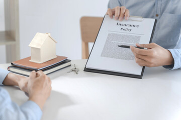 Real estate agent meeting customer with insurance policy about house contract.