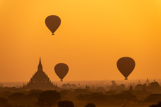 Bagan, Myanmar - 7 february 2014: Ballons flying over temples of Bagan at sunrise.