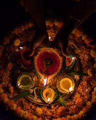 Female hands holding a diya or lamp with use of selective focus 