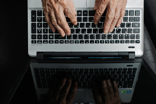 Senior person working on laptop