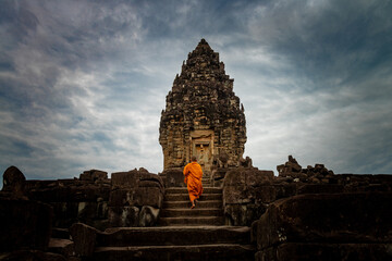 SIEM REAP, CAMBODIA - 15 June 2014: Monk at sunset. Bakong Temple, Roluos Group, Angkor Park.