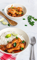 Chicken Curry Garnished with Curry Leaves Top Down Vertical Photo on White Background