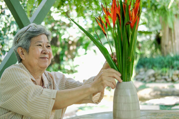 old asian elderly senior elder woman arranging flower bouquet