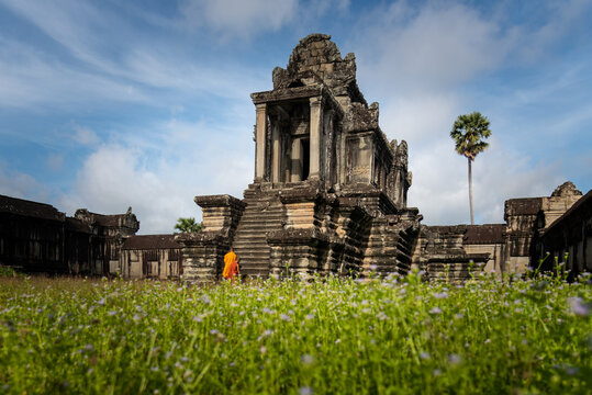 SIEM REAP, CAMBODIA - 16 August 2014: Monks start to climb stairs of ancient library in Angkor Wat