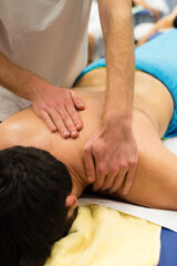 Obraz na płótnie Canvas A masseur performs a back massage on a patient