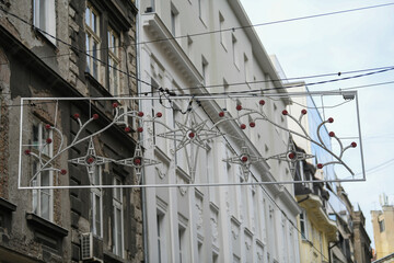 Workers set up New Year’s and Christmas lights and decoration on the streets of city