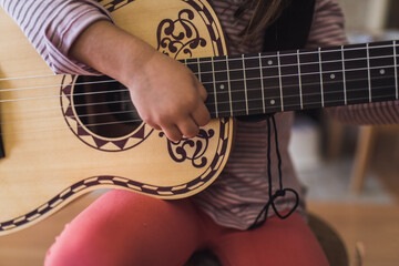 Ornate 6-string acoustic guitar held by 6 yr old child
