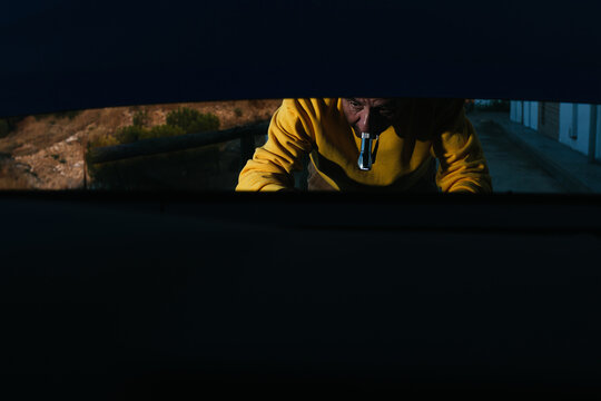 Senior man outside car at night