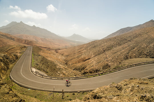 FUERTEVENTURA, SPAIN - 1 MARCH 2018: Panoramic view of winding road and cyclist viewpoint of Sicasumbre, Fuerteventura.