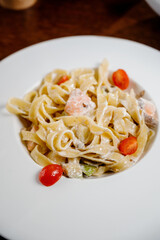 Plate with delicious Chicken Alfredo on table