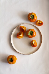 Fresh bright orange autumn persimmon on white background