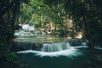 beautiful deep forest waterfall flow downward rapidly to each step