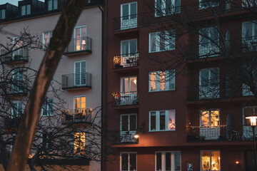 Building in Stockholm decorated with yellow light garlands. Windows and balconies of the house. Winter, christmas decoration