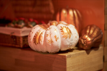 Painted pumpkin. Decorated Pumpkin in gold color. Halloween celebration concept. Pumpkin. Pumpkin decorations.