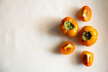 Fresh bright orange autumn persimmon on white background