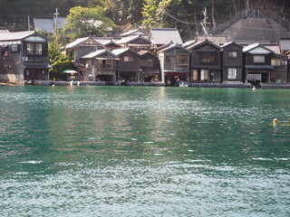 Spectacular view of Sea of Japan coast olf fishing village of Ine in Kyoto prefecture in Japan with old fishing houses, blue sky and turquoise waters of a bay on a sunny day