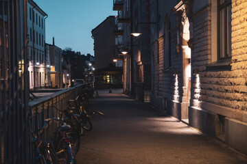 Scenic view of the evening street in Stockholm. Bicycles are parked along the fence