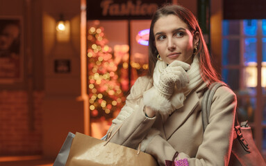 Beautiful woman doing Christmas shopping and thinking