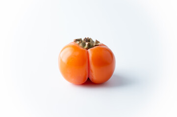 Ripe persimmon fruit on a white background.