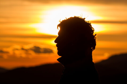 Silhouette of a man's head at sunset