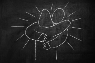 Hug concept. Drawing on a chalkboard. Support service for those in need.