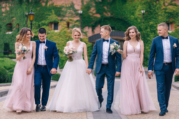 Groomsmen and bridesmaids walking on wedding ceremony - Powered by Adobe