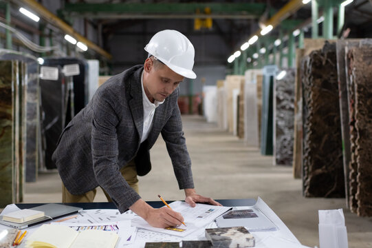 Focused architect creating new blueprint