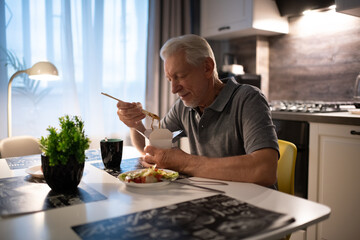 Senior man eating delivery food