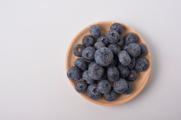 Berry background. Fresh berry blueberries on a white background. Concept of healthy and diet food. Flat lay, top view, Ripe blueberries with copy space for text, shallow DOF